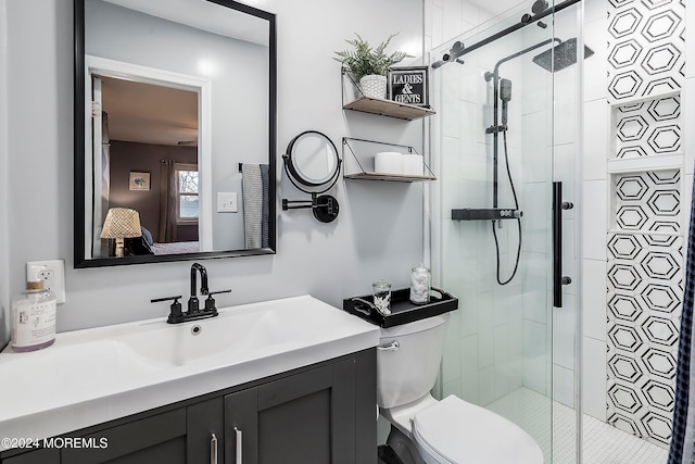 bathroom featuring vanity, toilet, and an enclosed shower