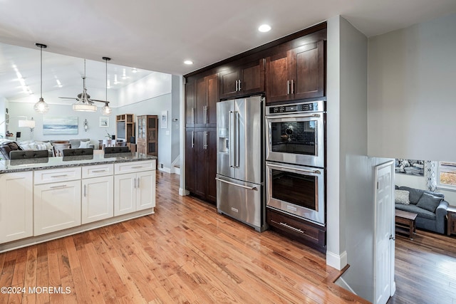 kitchen featuring dark brown cabinets, stainless steel appliances, light hardwood / wood-style flooring, stone counters, and hanging light fixtures