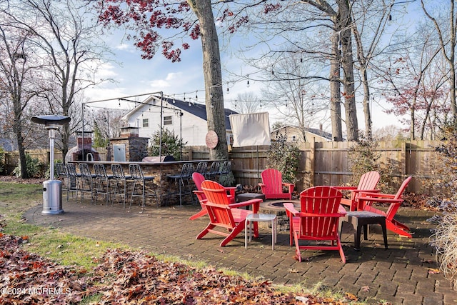 view of patio / terrace with a bar and a fire pit