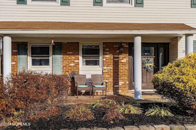 view of exterior entry featuring a porch