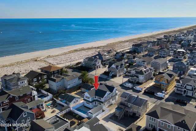 birds eye view of property featuring a water view and a view of the beach