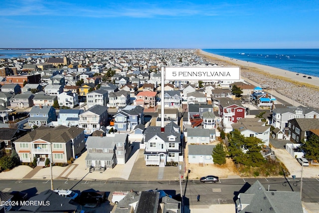 birds eye view of property featuring a water view and a view of the beach