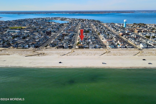 bird's eye view featuring a view of the beach and a water view