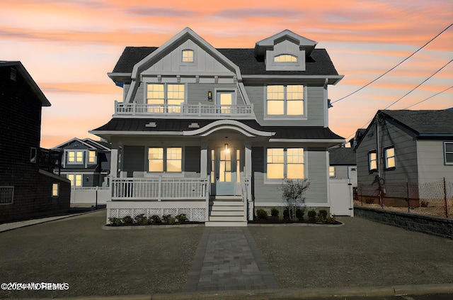 view of front of house with covered porch and a balcony