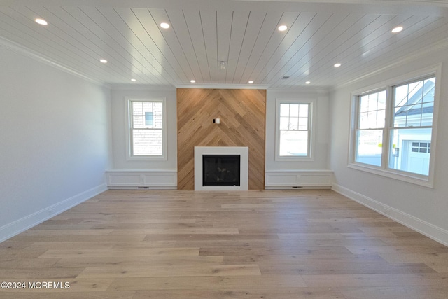 unfurnished living room with wooden ceiling, plenty of natural light, and light hardwood / wood-style floors