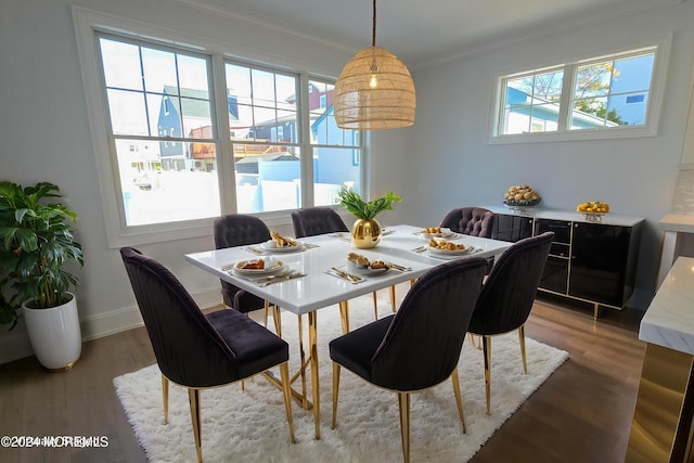 dining space with ornamental molding, dark wood-type flooring, and a wealth of natural light