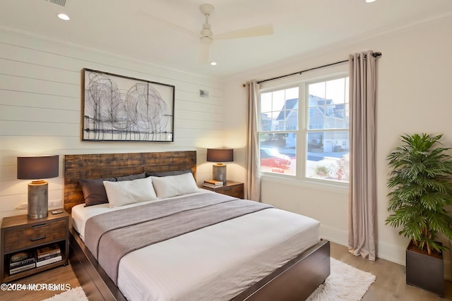 bedroom with light hardwood / wood-style flooring and ceiling fan