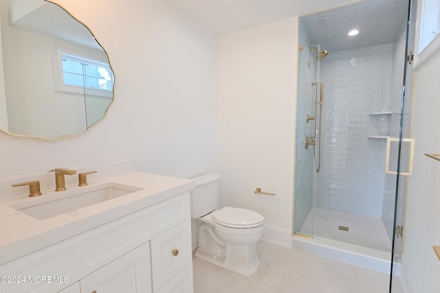 bathroom featuring tile patterned flooring, vanity, toilet, and walk in shower