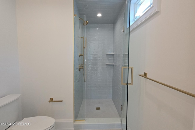 bathroom with walk in shower and toilet