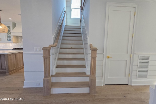 stairs featuring hardwood / wood-style floors