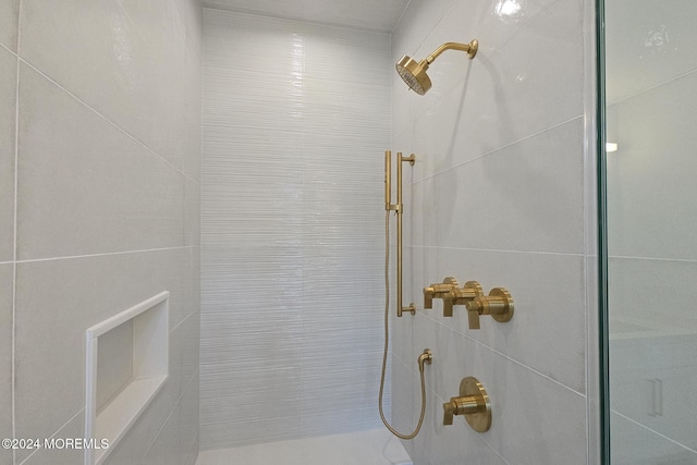 bathroom with tiled shower