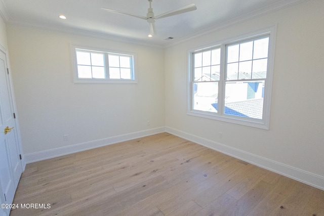 empty room with ceiling fan, ornamental molding, a healthy amount of sunlight, and light wood-type flooring