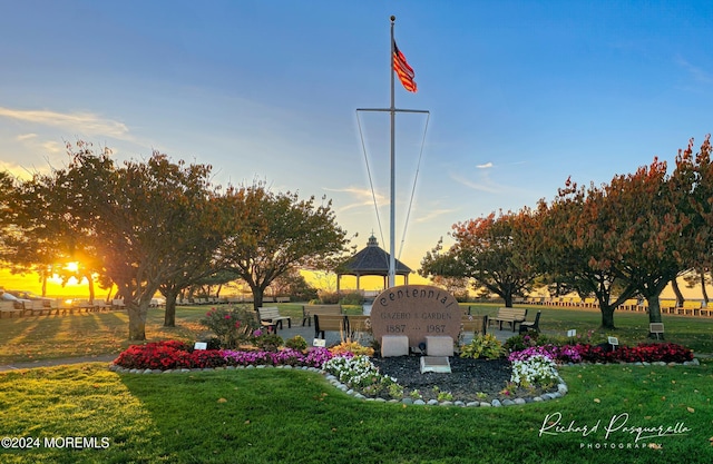 view of property's community with a lawn and a gazebo