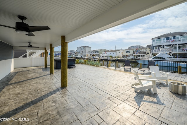 view of patio / terrace featuring a water view and ceiling fan