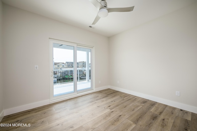 empty room featuring ceiling fan and light hardwood / wood-style flooring