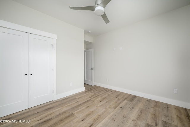 unfurnished bedroom with light wood-type flooring, a closet, and ceiling fan