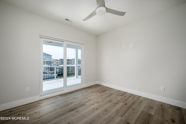 spare room featuring ceiling fan and hardwood / wood-style flooring