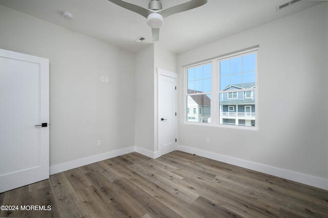 empty room featuring ceiling fan and hardwood / wood-style floors