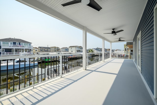 view of patio with a balcony and a water view