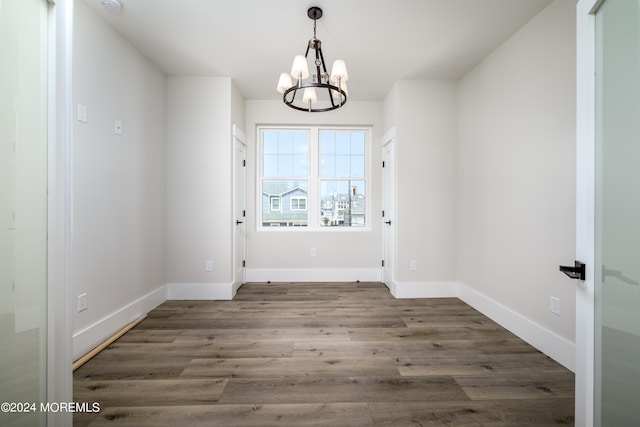 interior space with dark hardwood / wood-style flooring and a notable chandelier