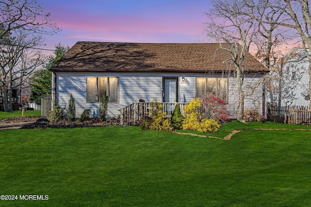 property exterior at dusk with a lawn