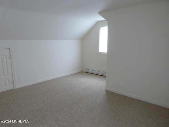 bonus room with light carpet, lofted ceiling, and a baseboard heating unit