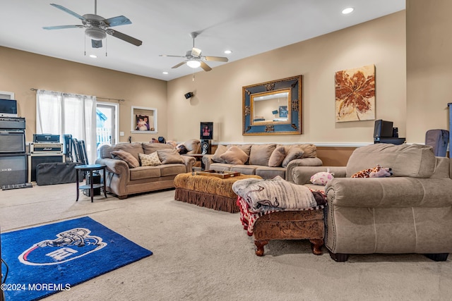 carpeted living room with ceiling fan