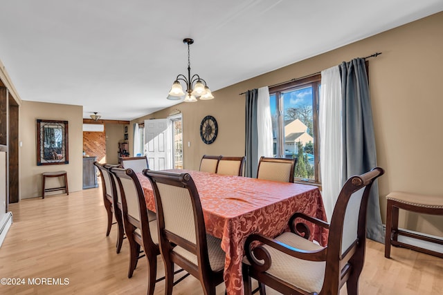 dining room featuring an inviting chandelier and light wood-type flooring