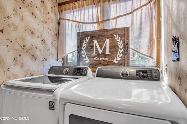 laundry room featuring washer and clothes dryer and a healthy amount of sunlight