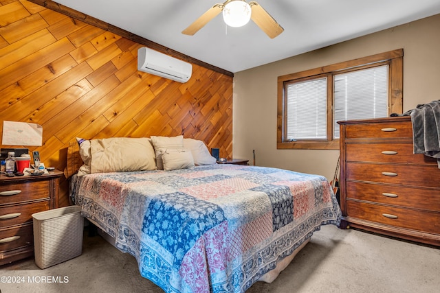 bedroom with a wall mounted air conditioner, carpet, ceiling fan, and wood walls