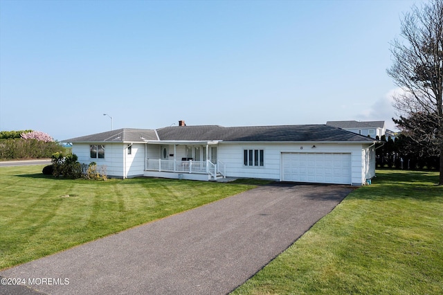 single story home with a front yard, a porch, and a garage