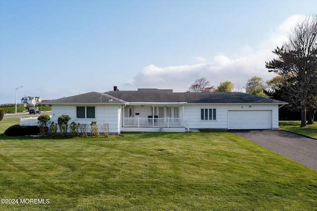 ranch-style house with a front lawn, a porch, and a garage