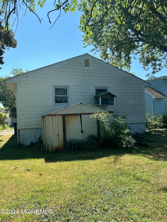 rear view of property with a lawn