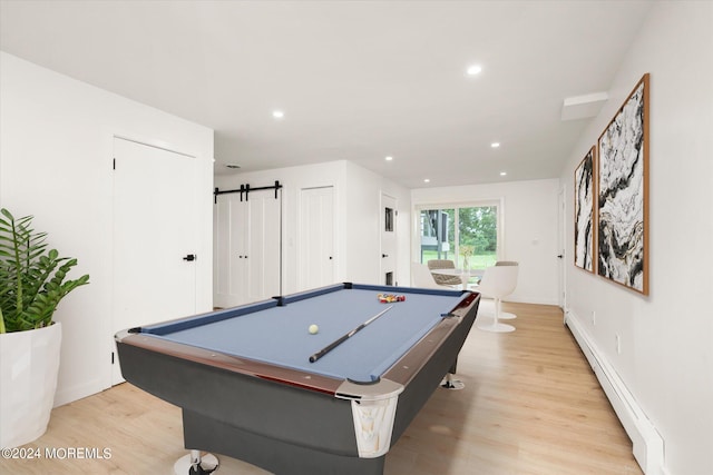 playroom with a barn door, a baseboard radiator, light hardwood / wood-style floors, and billiards