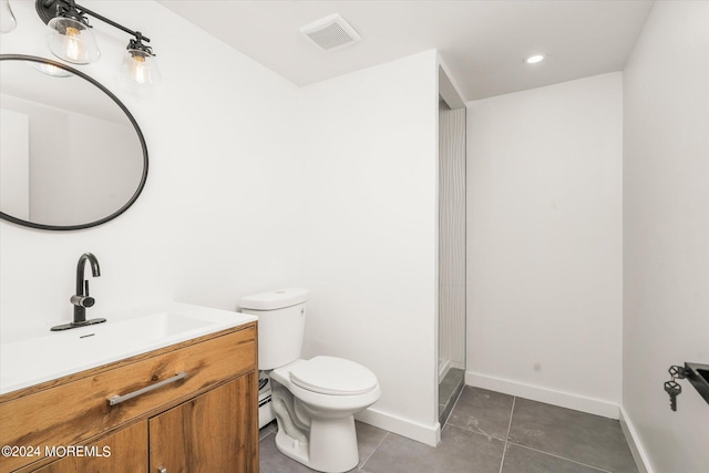 bathroom with tile patterned floors, vanity, and toilet