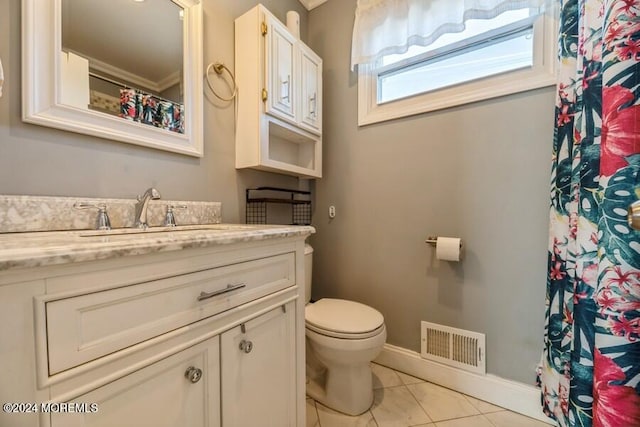 bathroom featuring tile patterned flooring, vanity, and toilet