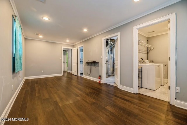 interior space featuring dark hardwood / wood-style floors, ornamental molding, and washing machine and clothes dryer