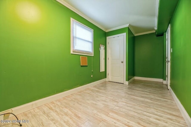 unfurnished bedroom featuring ornamental molding and light wood-type flooring