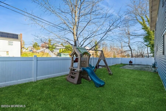 view of play area featuring a patio area and a yard