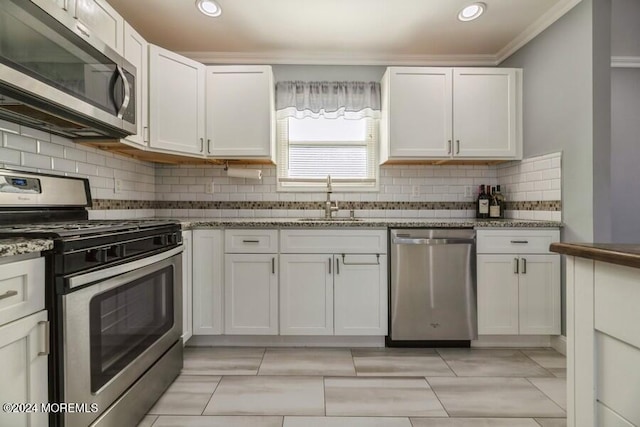 kitchen with white cabinetry, sink, and stainless steel appliances