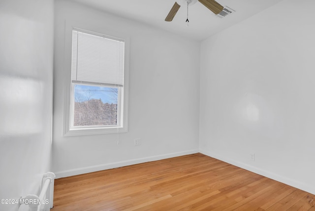 spare room featuring light hardwood / wood-style flooring and ceiling fan