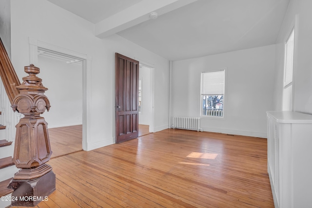 spare room with radiator and light hardwood / wood-style flooring