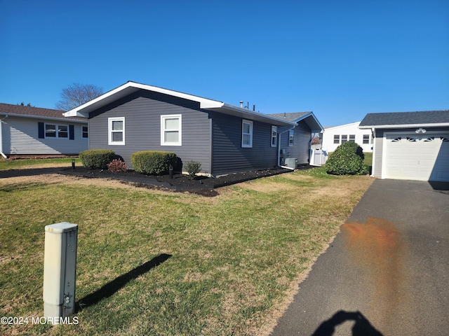 view of property exterior featuring a garage and a yard