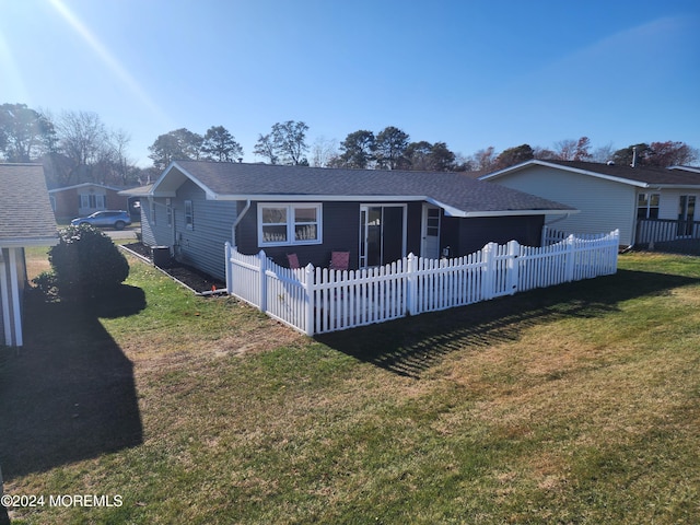 rear view of house with a yard