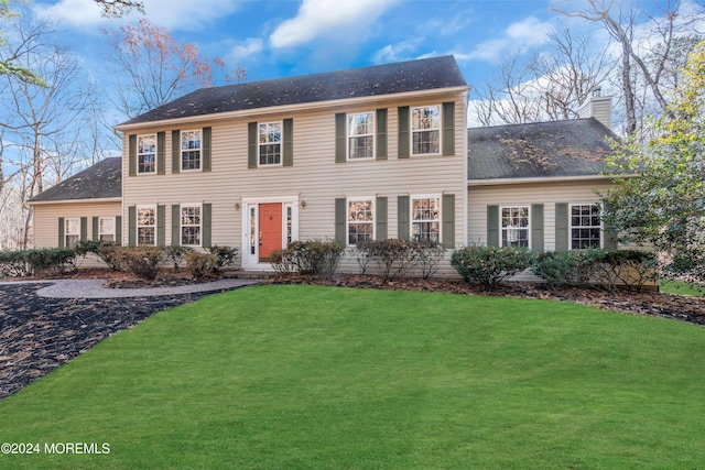 colonial home with a front lawn