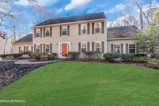 colonial-style house with a front lawn