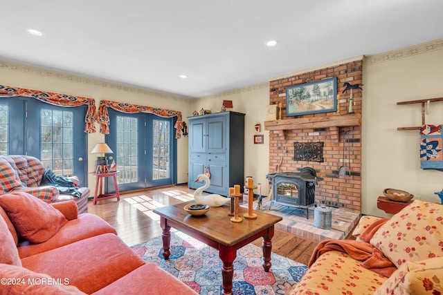 living room with light hardwood / wood-style floors and a wood stove