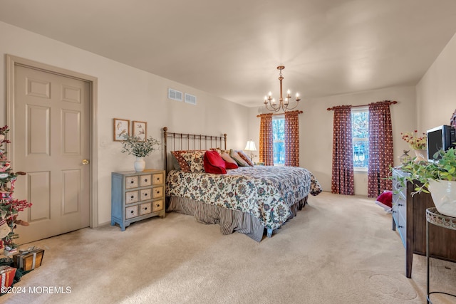 carpeted bedroom with a chandelier