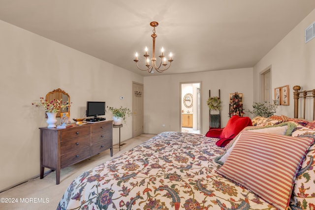 carpeted bedroom featuring ensuite bath and an inviting chandelier