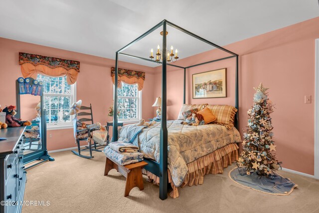 carpeted bedroom with a chandelier